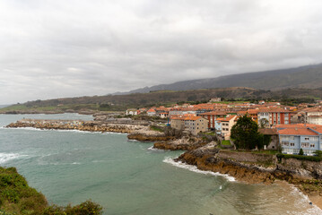 Panoramic and aerial view of the coast of Llanes and the Sablón beach with its golden sand on a cloudy day in the province of Asturias.