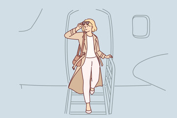 Woman gets off airplane, having arrived on business trip on private flight to conclude contract