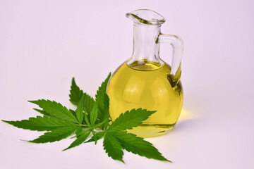 Hemp oil in a bottle and hemp seeds on a white background
