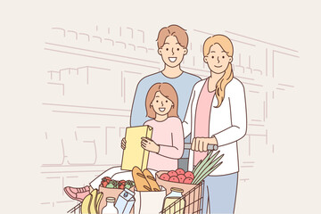 Happy family in supermarket with basket full of products to prepare delicious and healthy meal