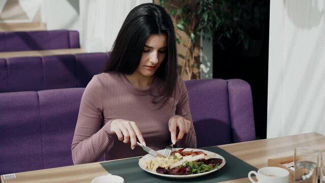 Woman having breakfast and drinking coffee in a beautiful restaurant Portrait