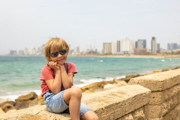 European tourist family with children, visiting Tel Aviv, Israel, enjoying day walk