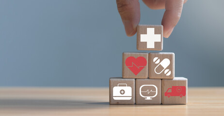 Businessman putting health icons on wooden cubes, concept for health insurance and life insurance