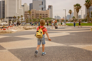 European tourist family with children, visiting Tel Aviv, Israel, enjoying day walk