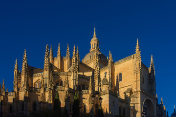 Segovia cathedral in Spain, with its stunning Gothic architecture, set against a blue background