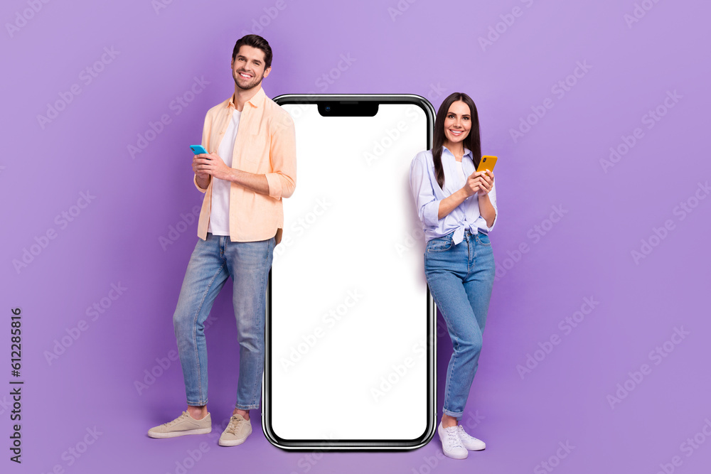 Poster full size portrait of two nice cheerful people use smart phone big empty space poster isolated on pu