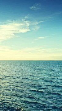 Blue sky and sea water surface, horizon, vertical phone wallpaper