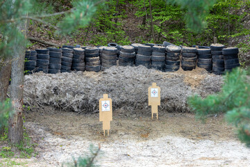 Wooden targets in a shooting range set up in a forest ravine.