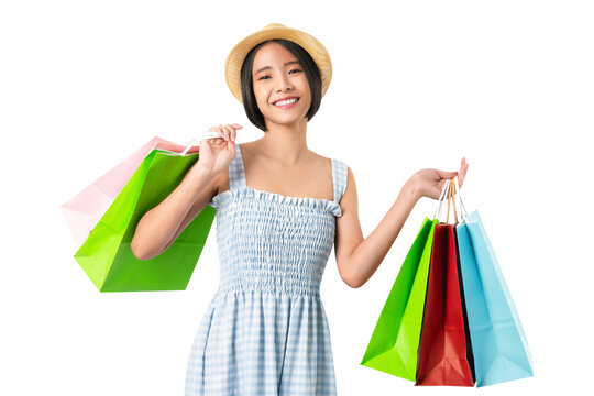 Young smiling asian woman holding multicolour shopping bags and looking isolated on png background.