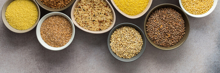 Various grain cereals in bowls banner, top view