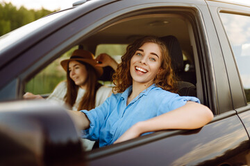 Two young women on car trip having fun. Lifestyle, travel, tourism, nature, active life.