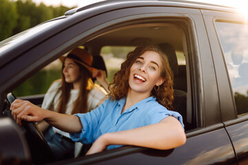 Two young women on car trip having fun. Lifestyle, travel, tourism, nature, active life.