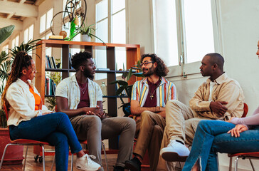 Five diverse people having conversation during group therapy.