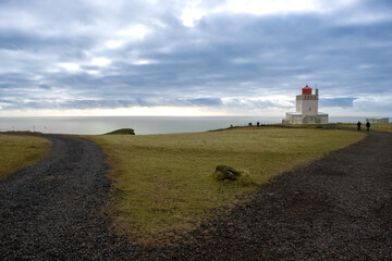 Fototapeta na wymiar Dyrholaey Lighthouse, Atlantic ocean and cloudy sky, Iceland