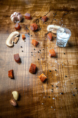Pieces of meat laid out on the table with a glass of salt