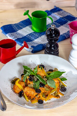 Meatballs in tomato sauce, garnished with basil in bowl on wooden table. View from above, top studio shot