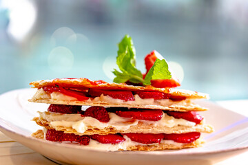 milfey cake with cream and strawberries and cup of coffee