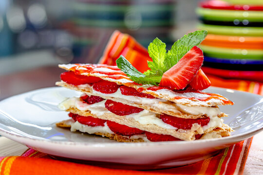 milfey cake with cream and strawberries and cup of coffee
