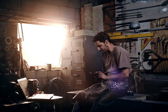 Blacksmith texting in forge