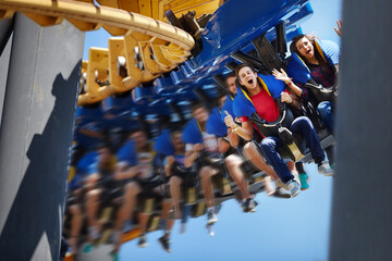 Young man screaming on amusement park ride