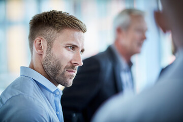 Serious businessman listening in meeting