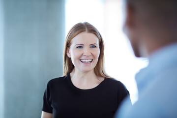 Smiling businesswoman talking to businessman