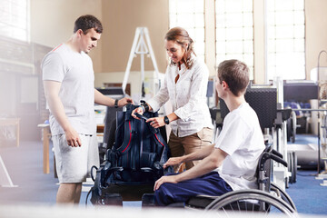Physical therapists with man in wheelchair