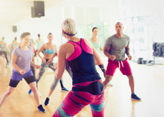 Fitness instructor leading aerobics class