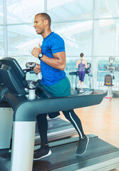 Man running on treadmill at gym