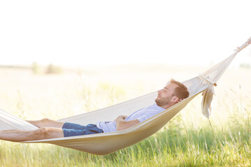 Young man sleeping in summer hammock