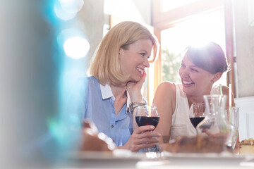 Smiling women drinking wine
