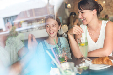 Family laughing at cafe table