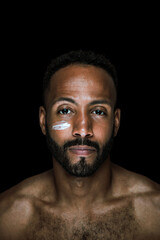 Fototapeta premium Image of a young man taking care of his skin