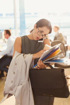 Stressed businesswoman struggling to multitask in office