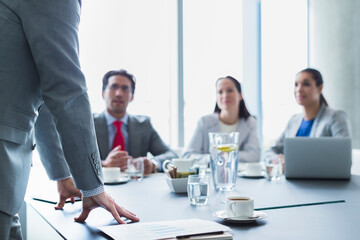 Businessman leading meeting in conference room