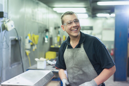 Smiling worker in steel factory
