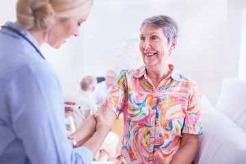 Doctor checking senior woman‚Äôs arm in checkup