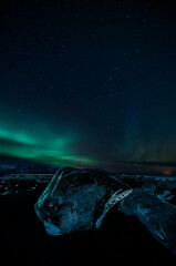 Northern lights over icy night landscape Jokulsarlon glacier, Iceland