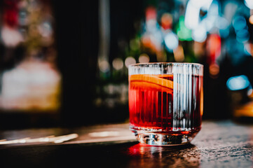 Cocktail Negroni with gin, campari martini rosso and orange. negroni cocktail in bar