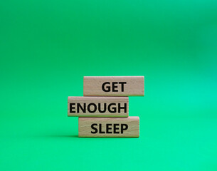 Get enough sleep symbol. Wooden blocks with words Get enough sleep. Beautiful green background. Healthy lifestyle, medical and Get enough sleep concept. Copy space.