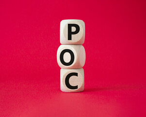POC - Proof of Concept symbol. Wooden cubes with words POC. Beautiful red background. Business and...