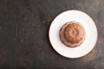 Chocolate jelly on black concrete, top view, copy space.