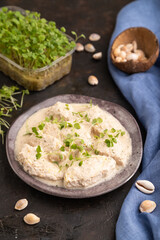 Stewed chicken fillets with coconut milk sauce and rucola microgreen. side view, selective focus.