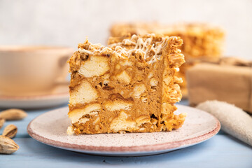 Traditional lithuanian cake shakotis with cup of coffee on blue, side view, selective focus.