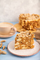 Traditional lithuanian cake shakotis with cup of coffee on blue, side view, selective focus.