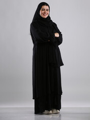 saudi arabian woman lady standing wearing  hijaab looking infront side view smiling