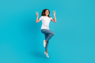 Fototapeta na wymiar Full length size photo of lovely glad cheerful girl jumping having fun isolated on bright blue color background