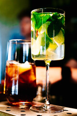 bartender making cocktail in glass on the bar counter