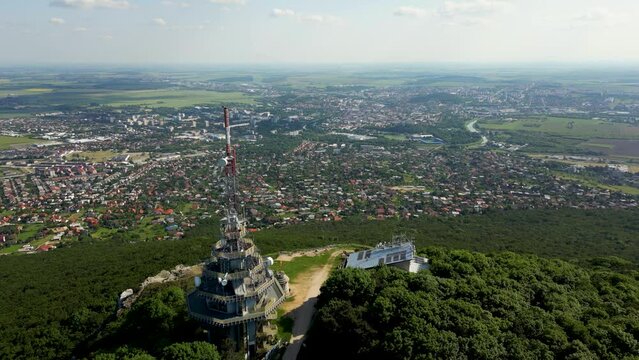 Drone is flying past Pyramid Radio tower on Zobor Mountain, view of Nitra, 4k