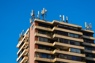 block of flats with antennas on the roof.